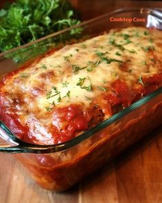 a glass casserole dish filled with meat and cheese