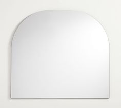 an oval shaped mirror mounted on the wall