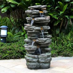 there is a fountain made out of rocks