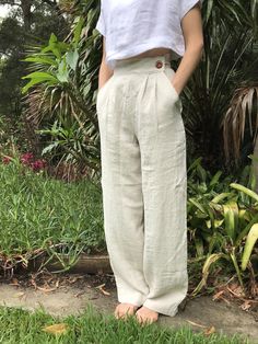 "LINEN HIGH WAISTED STRAIGHT LEG TROUSERS - CUSTOM ITEM** High waisted vintage style trousers. Tailored at the waist, pleated at the front, two pockets at the hips, and darts at the back of the waist for a defined fit. Pocket opening button and press stud closure. Wide/straight leg finishing below the ankle. Tailored to your height FARGELAND is an independent, female-owned business. All of my clothing is designed and handmade by me in my art studio in Bulli, Australia. Just south of Sydney. When Cream Relaxed Fit Full-length Pants, Cream Relaxed Fit Pants, Full Length Cream Pants For Summer, Cream Full Length Summer Pants, White Linen Full-length Bottoms, Neutral High-waist Relaxed Fit Pants, Neutral High Waist Relaxed Fit Pants, Neutral Relaxed Fit High Waist Wide Leg Pants, High Waist Wide Leg Pants In Neutral Color