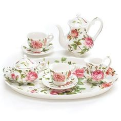 a tea set with pink roses on it and saucer, cups and saucers