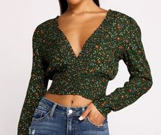 Show off your sweet side in a floral crop top that brings the charm. The crop top features a plunging V-neckline. a partially smocked bodice. and a pretty floral print. Complete your look with high waist jeans and ankle booties.Fit & Features Plunging V-neckline Partially smocked knit bodice Long sleeves Floral print Cropped hem Open back with back ties Form hugging fit. moderate stretch Floral Crop Tops, Waist Jeans, Woven Top, Sweet Dress, Sweater Coats, Cropped Tank Top, Floral Maxi Dress, High Waist Jeans, Ankle Booties