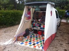 a camper van with its door open on the ground