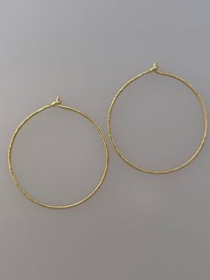 Beautifully simple pair of solid 18k yellow gold hoops with a stunning hand hammered texture.  Hoop diameter approx: 3cm  You can see other single/pairs of earrings here: www.etsy.com/uk/shop/LapisAndCoral?section_id=16618273&ref=shopsection_leftnav_2 These are made to order, so please allow up to 10 working days for delivery. You can view more beautiful jewellery here: LapisAndCoral.etsy.com Hammered Gold Hoop Earrings In Recycled Gold, Gold Hammered Hoop Earrings In Recycled Gold, Hammered 14k Gold-filled Hoop Earrings, Hammered Yellow Gold Circular Earrings, Yellow Gold Hammered Circle Earrings, Hammered Yellow Gold Earrings Made Of Recycled Gold, Hammered Yellow Gold Hoop Earrings In Recycled Gold, Hand Forged Brass Hoop Earrings In Yellow Gold, Minimalist Hammered Yellow Gold Earrings