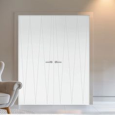 a white chair sitting in front of a sliding glass door that has vertical lines on it