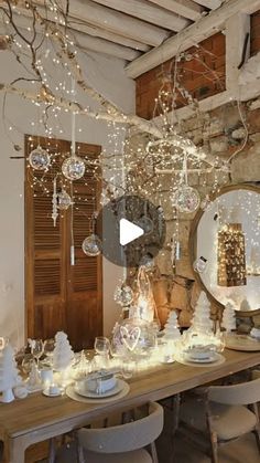 a dining room table covered in christmas lights and ornaments with a mirror hanging from the ceiling