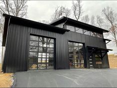 a black house with large windows and doors