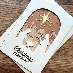 a christmas card with the nativity scene cut out on it's front and side