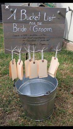 a bucket list for the bride and groom on display in front of a wedding sign