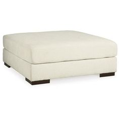 a white footstool sitting on top of a white floor