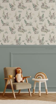 a teddy bear sitting on a chair in front of a wallpapered with rabbits