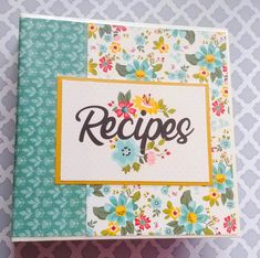 a recipe book with flowers and the word recipes written on it in cursive writing