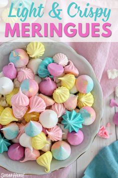 a white bowl filled with marshmallows on top of a pink table cloth