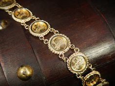 "This exquisite vintage bracelet comes with an appraisal card from North American Gem Lab of Bellevue Washington appraising for $2,700.00. It features 10 Saint-Gaudens double eagle replica coins dated 1914. This bracelet is in excellent condition! The bracelet is hallmarked 14k and measures 13mm wide by 7\" long. Items $100 or more are shipped in a velvet gift box. Items less then $100 will be shipped in a cardboard box with tissue and a fabric ribbon, ready for gift giving or just for safekeepi Antique 14k Stamped Gold Bracelet, Antique Gold Bracelet Stamped 14k, Ceremonial 14k Gold Jewelry With Historical Design, Elegant Ceremonial Coin Jewelry, Formal Antique Gold Jewelry Stamped 14k, Vintage Yellow Gold Jewelry With Historical Design, Antique Gold Jewelry With Jubilee Bracelet, Victorian Gold Bracelet For Ceremonial Occasions, Elegant Gold-tone Coin Jewelry