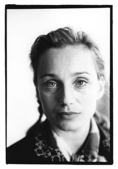 a black and white photo of a woman looking at the camera with an intense look on her face