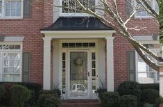 a red brick house with white front door