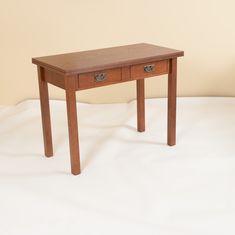 a small wooden table with two drawers on one side and an open drawer on the other