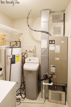 a bathroom with a sink, water heater and other items in the room around it