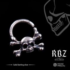 a skull and crossbone ring is shown on a black background with the words, solid sterling