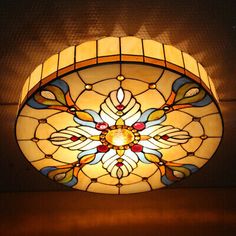 a stained glass ceiling light hanging from the ceiling