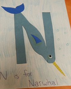 the letter m is for narwhale with a fish on it's tail