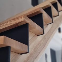 wooden shelves with black and white trims are lined up on the wall in front of mirrors