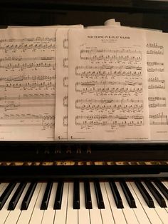 sheet music sitting on top of an upright piano