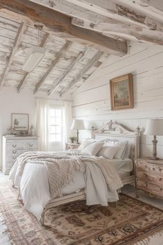 a bedroom with white walls and wooden beams on the ceiling is decorated in rustic style