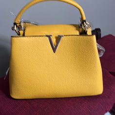 New And Beautiful Yellow V Bag With Zippers Inside And Two Compartments And A Zipper On The Outside To Hold By Hand Or Shoulder Cheap Yellow Double Handle Satchel, Luxury Yellow Large Capacity Satchel, Yellow Evening Bags With Handles, Yellow Satchel With Top Carry Handle For Errands, Yellow Crossbody Bag With Top Carry Handle, Gold Bag With Top Carry Handle For Errands, Yellow Top Handle Bag For Errands, Yellow Color, Shoulder Bags