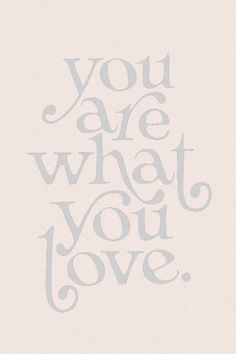 the words you are what you love written in grey ink on a white paper background