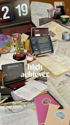 a pile of papers and laptops with the words high achiever written on them