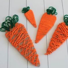 three carrots made out of string sitting on a table