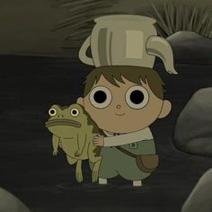 a boy holding a frog in front of him with a pot on his head and another frog standing next to him