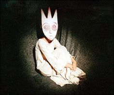 a person wearing a white mask sitting on the ground