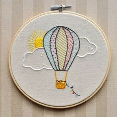 an embroidery project with a hot air balloon in the sky