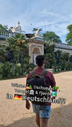 a man with a backpack is walking towards a building that has trees in the background