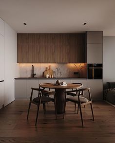 a table and chairs in a room with wood flooring, white walls and cabinets