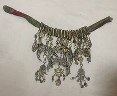 This antique necklace from Libya, North Africa is a very rare piece of traditional jewelry dating pre 18th century. Crafted from sterling silver gilt, it features intricate filigree details that add a touch of elegance to any collection. It is done with African symbolism and set with natural stones. The necklace is mounted to a naturally died linen neck band and it has acquired a wonderful patina from age. The necklace is perfect for those who appreciate the unique beauty of antique jewelry. It measures 14 1/2 inches wide by 6 3/4 inches up and down. There are a couple small losses and it is missing its original clasp/bail. African Symbolism, Traditional Necklace, Bib Necklaces, Antique Necklace, Unique Beauty, Libya, Traditional Jewelry, North Africa, Very Rare