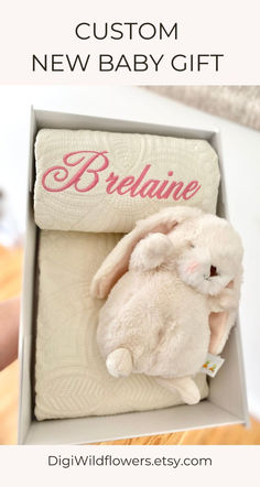 a white stuffed animal in a box with the words, custom new baby gift