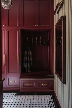 a red closet with black and white checkered flooring