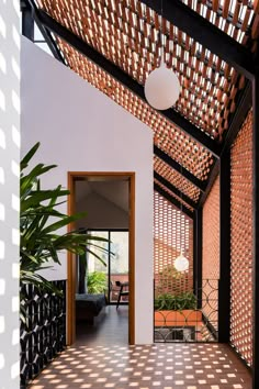 the inside of a house with tiled flooring and wooden pergolated roof covering