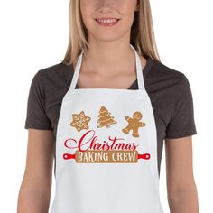 a woman wearing an apron that says christmas baking crew with gingerbreads on it