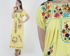 Vintage traditional Mexican Puebla maxi dress. Tailored chest with puffed cap sleeves.  Gathered and draped trapeze shift fit. Yellow soft cotton with bright floral hand embroidery. size estimate: S/M shoulders: 16" bust: 36" waist: 47" hips: 48" total length: 52.5" * Visit the shop * https://www.etsy.com/shop/americanarchive Model is 5'9" and measures 32" bust, 25" waist, 35.5" hips. Belts/accessories are not included unless noted in the description. Yellow Folk Dress For Spring, Multicolor Spring Maxi Dress For Fiesta, Cotton Maxi Dress With Floral Embroidery And Short Sleeves, Multicolor Maxi Dress For Spring Fiesta, Spring Fiesta Multicolor Maxi Dress, Short Sleeve Multicolor Embroidered Maxi Dress, Spring Embroidered Yellow Maxi Dress, Traditional Short Sleeve Maxi Dress For Spring, Spring Yellow Embroidered Maxi Dress