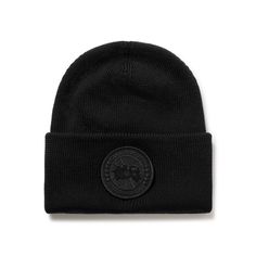 Canada Goose's beanie is knitted from wool that's soft and warm, so you can rely on it as soon as the leaves begin to fall. It's appliquéd with a monochromatic version of the brand's iconic 'Arctic Program' embroidered logo patch. Casual Wool Hat With Embroidered Logo, Winter Wool Hats With Embroidered Logo, Fall Casual Beanie With Logo Patch, Casual Fall Beanie With Logo Patch, Black Wool Beanie Cap, Winter Beanie With Embroidered Logo, Classic Black Wool Beanie, Black Wool Beanie For Fall, Classic Beanie With Embroidered Logo