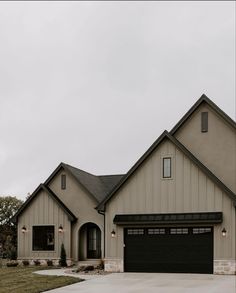 a large house with two garages on the front and one above it's door