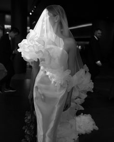 a woman in a wedding dress with flowers on it