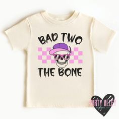 Our Bad Two the Bone Shirt is just what your rockstar kiddo needs for their 2nd birthday. This cozy t-shirt will have them lookin' cool, with its skull graphic. So crank the tunes and Rock On! All items purchased are made to order using a DTF (direct to film) transfers and an industrial heat press.  See shop announcement for current processing time. A "rush my order" listing is available in the add on/upgrade section, please message me beforehand if you will need to rush your order to make sure Band Merch T-shirt With Graphic Print For Birthday, Band Merch Graphic Print T-shirt For Birthday, Band Merch Graphic Print Top For Birthday, Birthday Band Merch Tops With Short Sleeves, Band Merch Tops For Birthday With Short Sleeves, Short Sleeve Band Merch Tops For Birthday, 2nd Birthday Halloween, Bad Two The Bone, 2nd Birthday Outfit