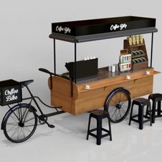 an old fashioned ice cream cart with two stools and a bike parked next to it