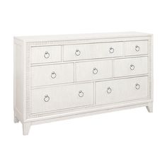 a white dresser with drawers and knobs