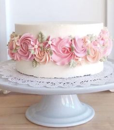 a white cake with pink flowers on top